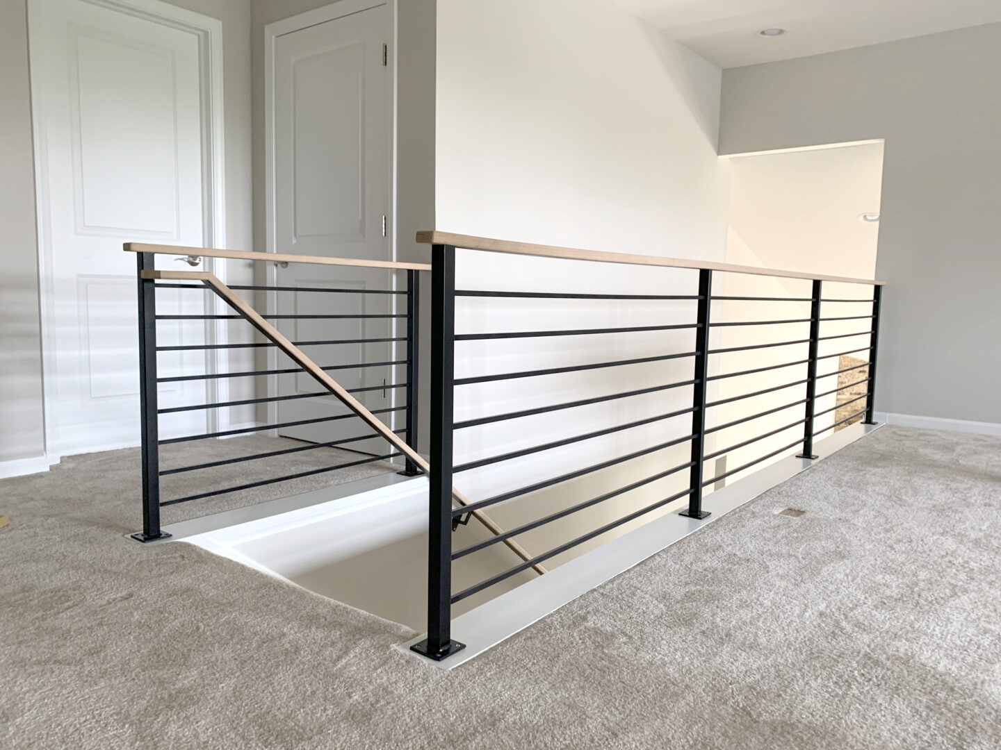 Custom wrought iron & wood railings urban modern painted satin black top entrance view