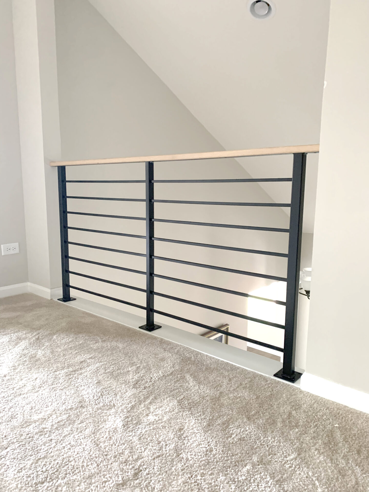 Custom wrought iron & wood railings urban modern painted satin black top of stairs view