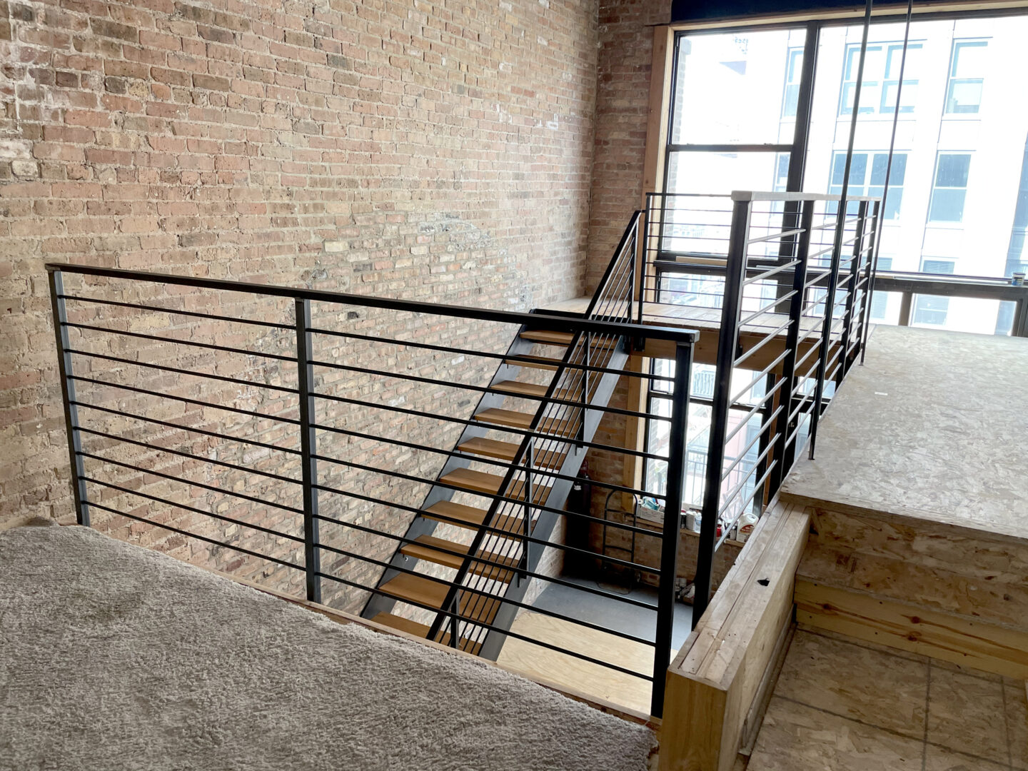 Custom wrought iron & wood stairs urban modern painted clear coat top staircase view