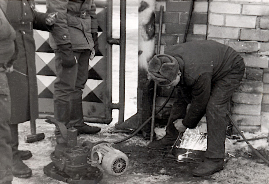 Peter installing engine for slide gate in army