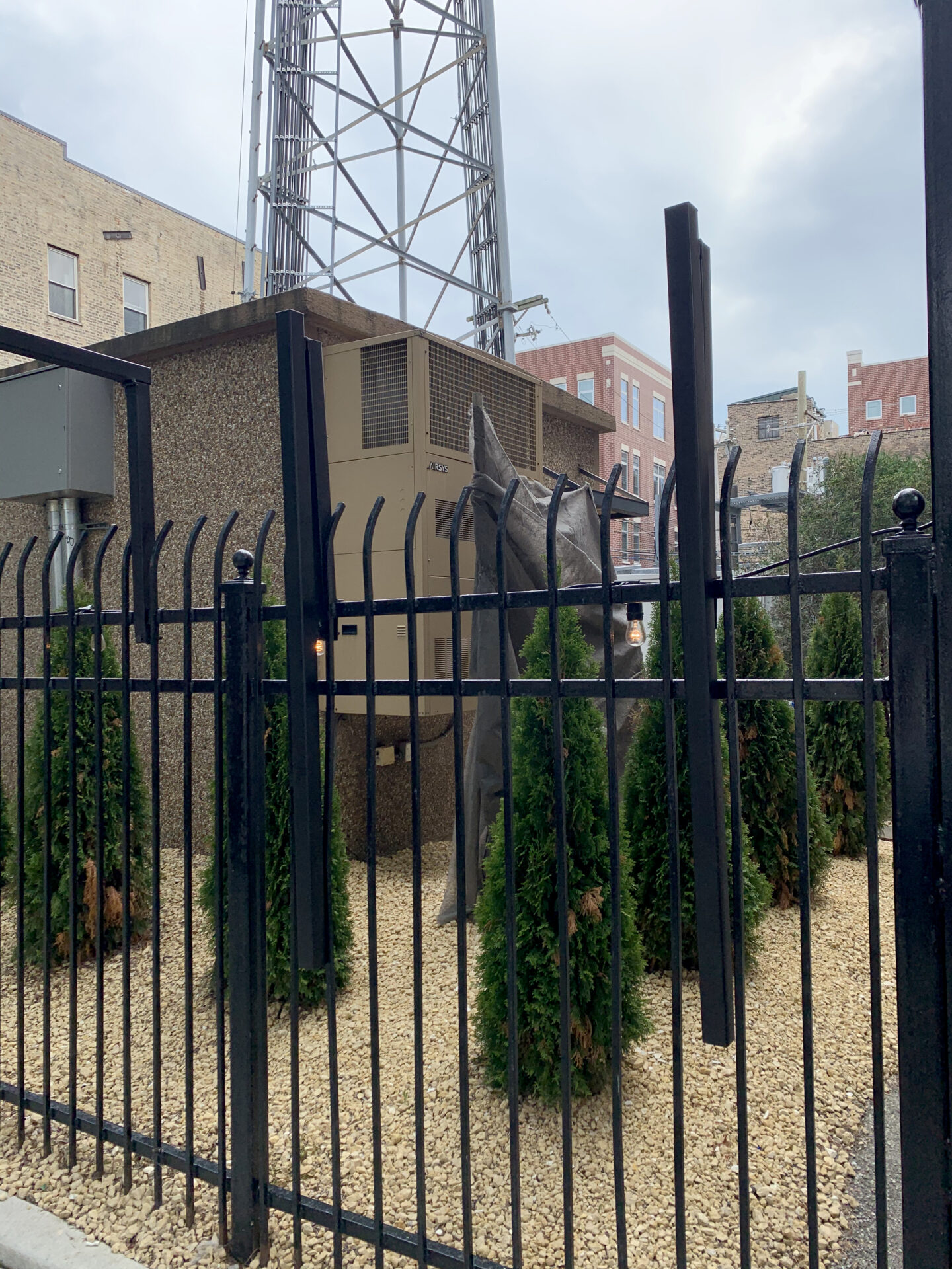 Traditional wrought iron commercial fence painted satin black in Chicago