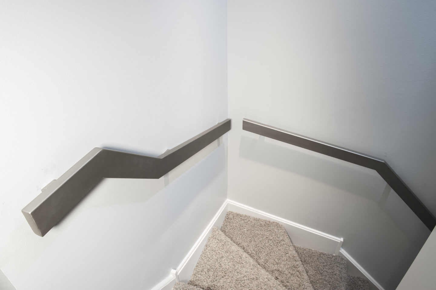 Custom contemporary wrought iron flat handrails painted silver for a client in Logan Square