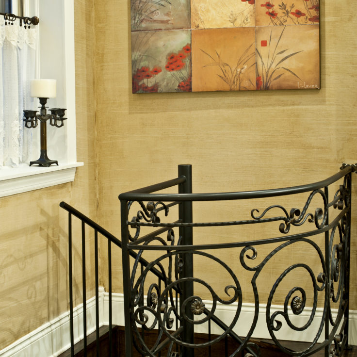 Custom french country wrought iron scroll railings painted gold patina-over-black for a client in Lincoln Park
