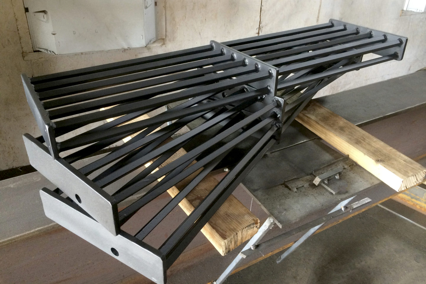Custom industrial wrought iron fire escape treads painted satin black for a client in Bucktown