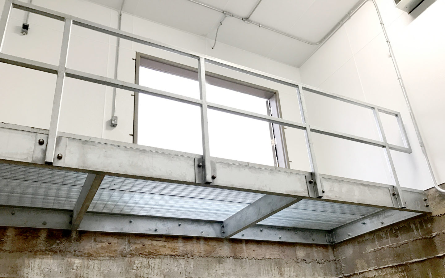 Custom industrial wrought iron mezzanine hot-dip-galvanized gray for a client in Lombard
