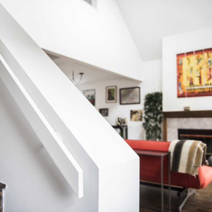 Custom minimalist aluminum flat handrails powder coated white for a client in Bucktown