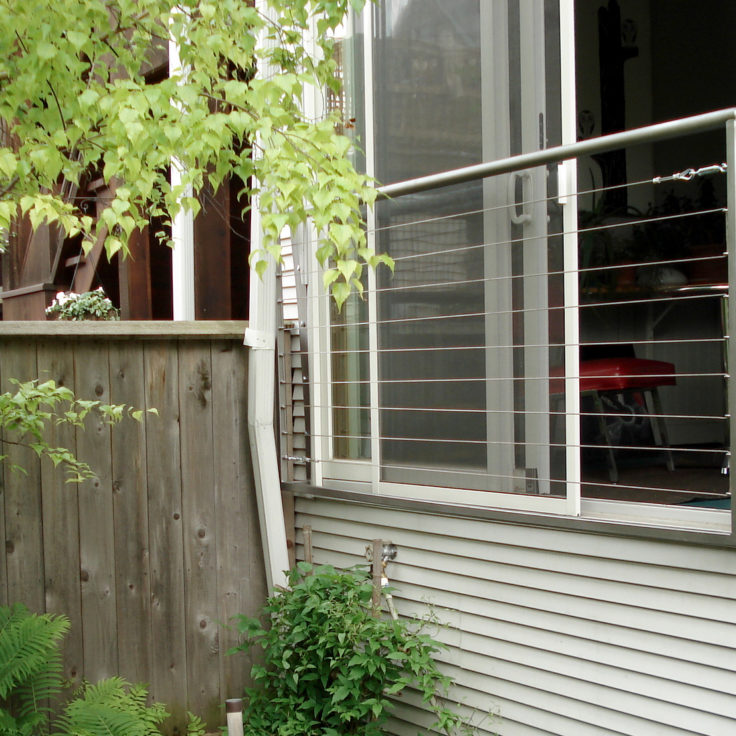 Custom minimalist wrought iron cable balcony painted silver for a client in Bucktown