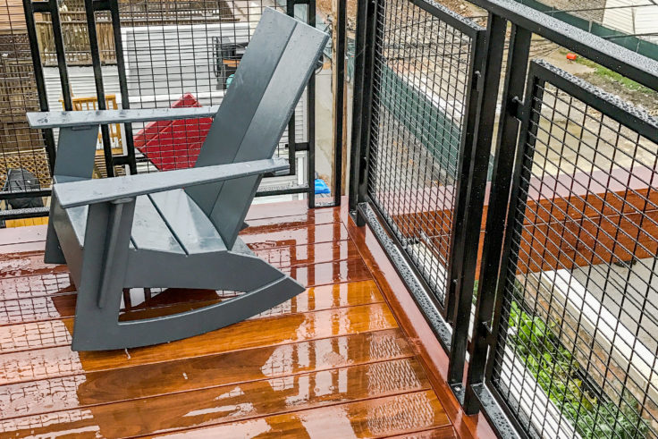 Custom industrial wrought iron mesh balcony powder coated black for a client in Bucktown