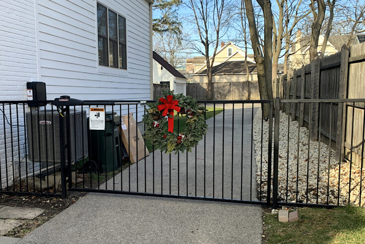 custom residential wrought iron motorized gate closed